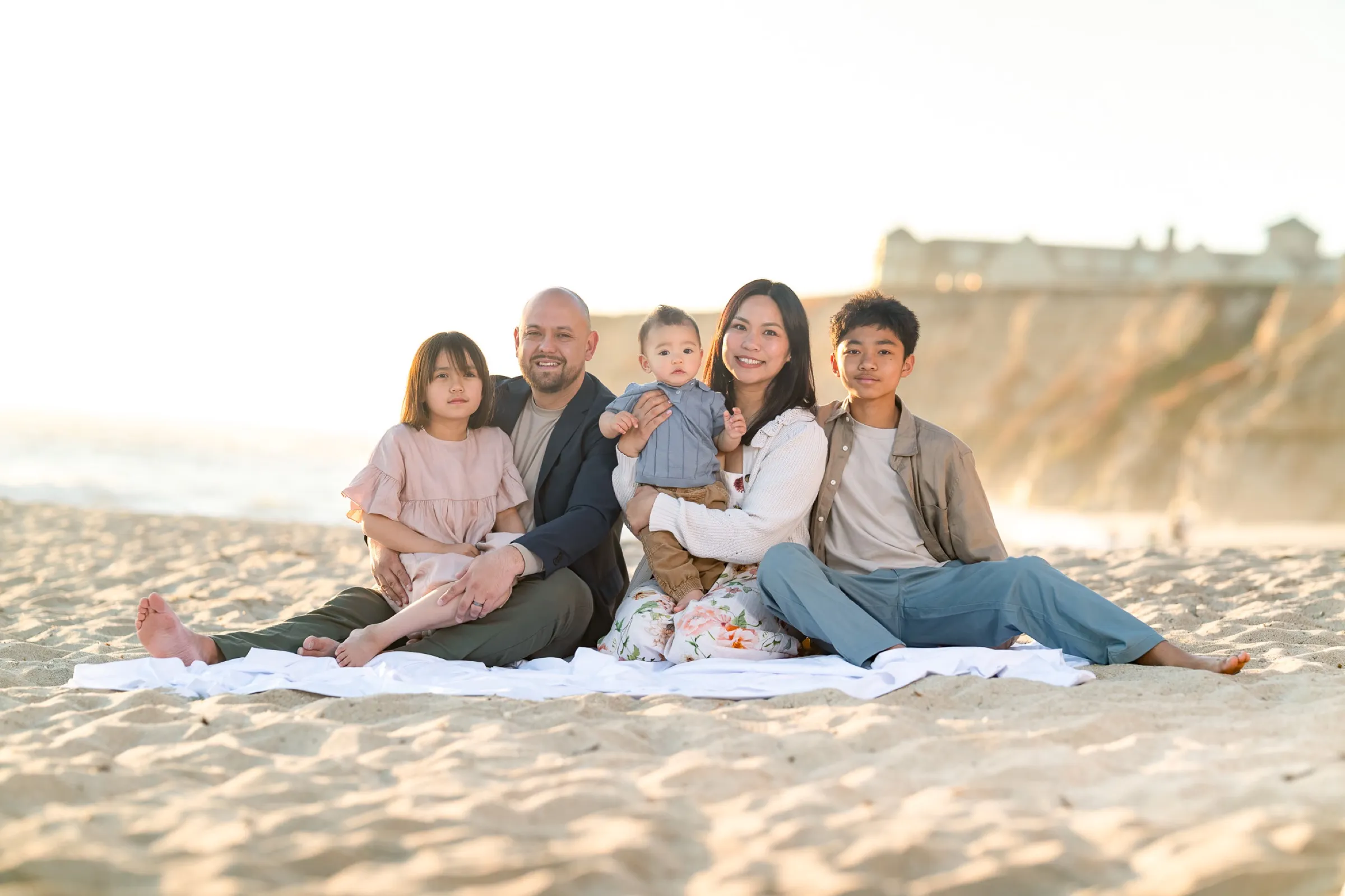 Family portrait on the beach at sunset