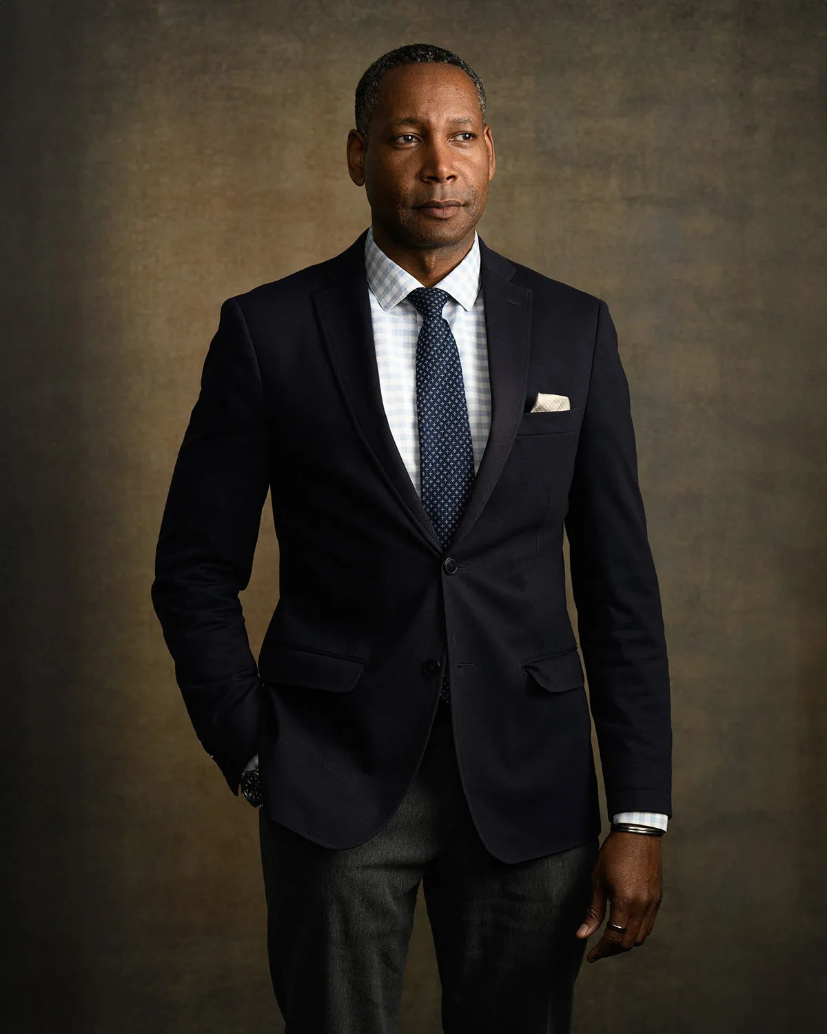 Man in a navy blazer and gingham shirt for a personal branding portrait