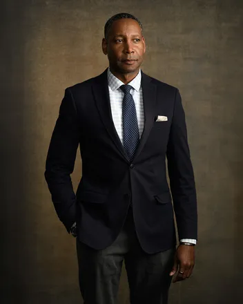 Man in a navy blazer and gingham shirt for a personal branding portrait