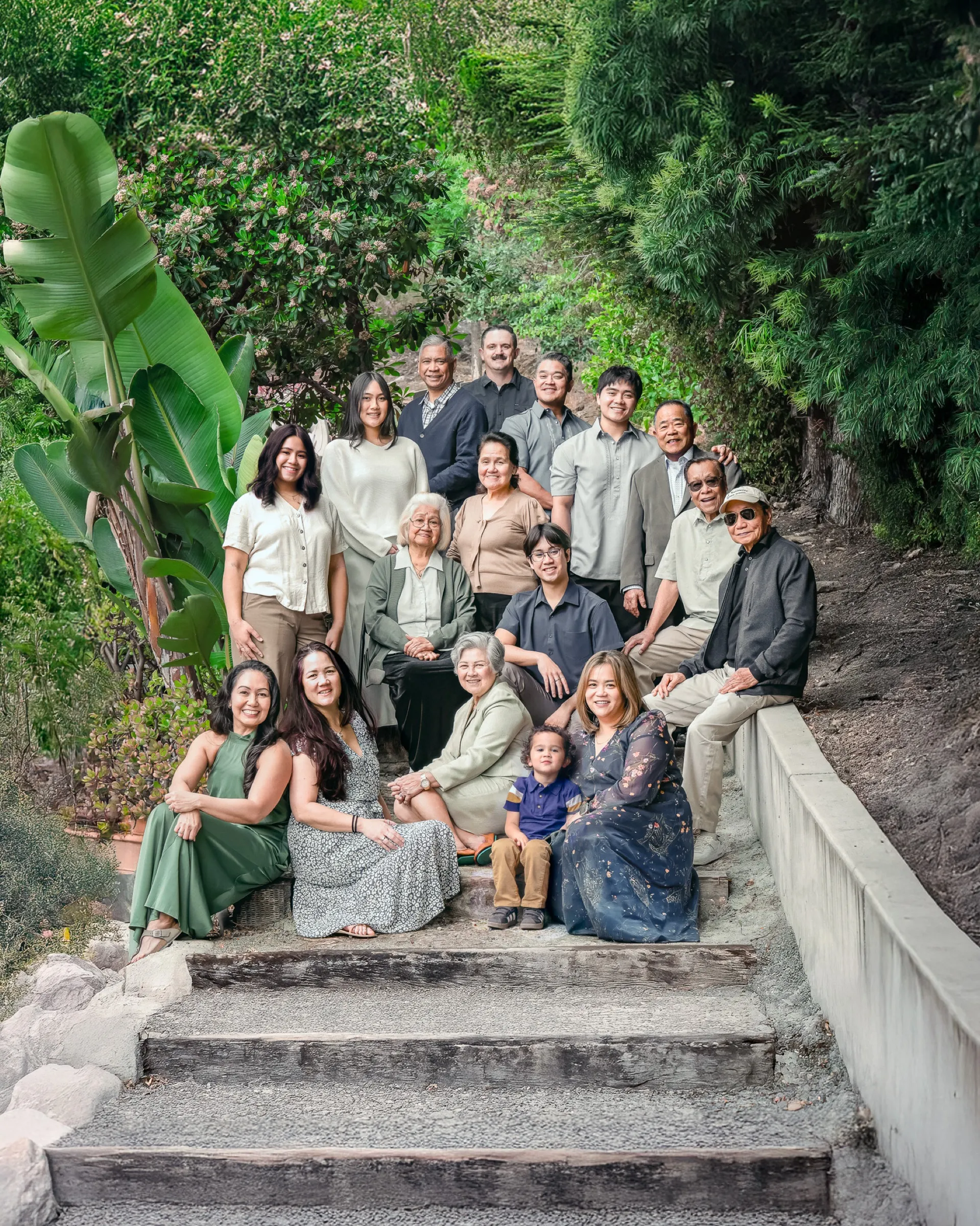 Multigenerational family portrait gathered on outdoor stone steps