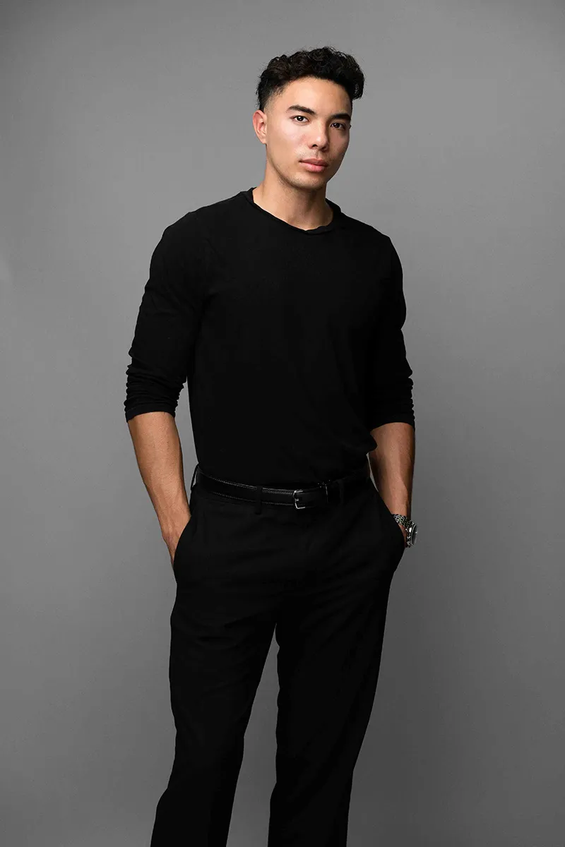 Young man in black attire for a studio headshot portrait